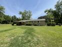 Single-story home with a covered porch, set on a large lot with mature trees at 6287 Sniders Hwy, Walterboro, SC 29488