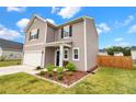 Charming home with a well-kept lawn, landscaping, and a welcoming front entrance at 716 Mcroy St, Moncks Corner, SC 29461
