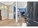 Elegant foyer showcasing hardwood floors, sophisticated lighting, and views into adjoining living spaces at 7302 Sanderling Ct, Hanahan, SC 29410