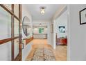 Inviting foyer with hardwood floors, decorative mirror and a glimpse of the kitchen, creating a welcoming entrance at 734 Fort Sumter Dr, Charleston, SC 29412