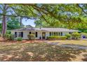 Beautiful home exterior featuring classic architectural details, mature trees, and manicured landscaping at 734 Fort Sumter Dr, Charleston, SC 29412