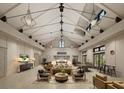 Bright and airy living room featuring high ceilings with exposed beams and modern light fixtures at 827 Gentle Breeze Dr, Summerville, SC 29486