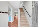 The home's entryway features stairs, wood floors, and views of the living area and kitchen at 9010 Maple Grove Dr, Summerville, SC 29485