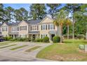 Inviting two-story townhomes boast well-maintained lawns and patterned concrete driveways at 9010 Maple Grove Dr, Summerville, SC 29485