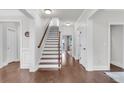 Elegant foyer with hardwood floors, staircase, and white trim throughout, creating a welcoming entrance at 911 Hunt Club, Charleston, SC 29414