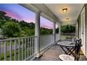 Inviting porch with stylish table and chairs, perfect for enjoying outdoor views and a peaceful atmosphere at 911 Hunt Club, Charleston, SC 29414