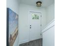 Inviting entryway with tiled floors, white trim, fresh paint, and light fixture at 977 Warrick Oaks Ln, Mount Pleasant, SC 29464