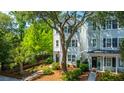 Stunning house with traditional siding, mature trees, and manicured landscaping, creating inviting curb appeal at 977 Warrick Oaks Ln, Mount Pleasant, SC 29464