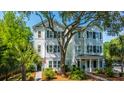 Beautiful home featuring traditional siding, mature trees, and manicured landscaping, enhancing curb appeal at 977 Warrick Oaks Ln, Mount Pleasant, SC 29464