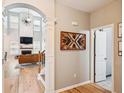 Bright hallway featuring hardwood floors, decorative archways, and a view into the living space at 1007 Whitlow Blvd, Summerville, SC 29483