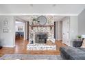 Comfortable living room with a brick fireplace, wooden flooring, and decorative accents at 101 Plantation Dr, Summerville, SC 29485
