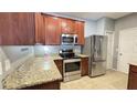 Modern kitchen with stainless steel appliances, granite countertops, and warm wood cabinets at 115 Hyrne Dr, Goose Creek, SC 29445