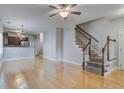 Bright living space with light wood floors and a staircase, offering a view into the adjacent kitchen area at 116 Venezia Ct, Ladson, SC 29456
