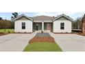 Attractive duplex with separate entrances, enhanced by a professionally designed yard at 119 Mims Academy Dr, Harleyville, SC 29448