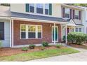 Attractive townhouse exterior featuring brick accents, manicured greenery, and a welcoming entrance at 1201 Pine Bluff Dr, Summerville, SC 29483