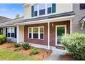 Charming townhouse featuring a brick facade, well-maintained landscaping, and inviting front entrance at 1201 Pine Bluff Dr, Summerville, SC 29483