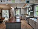 A gourmet kitchen features a large island, stainless steel appliances, and sleek cabinetry with stylish countertops at 1495 Keshi Pearl Dr, Mount Pleasant, SC 29466