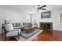 Cozy living room featuring a fireplace, hardwood floors, and stylish furnishings at 1514 Village Sq, Mount Pleasant, SC 29464