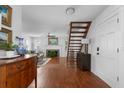 Open-concept living space with hardwood floors and a staircase with an interesting design at 1514 Village Sq, Mount Pleasant, SC 29464
