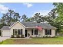 Charming one-story home with a manicured lawn and cozy front porch at 1583 Southwick Dr, Johns Island, SC 29455