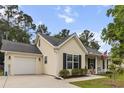 Inviting single-story home with vinyl siding, black shutters, and an attached garage at 1583 Southwick Dr, Johns Island, SC 29455