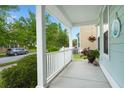 View from the covered front porch with white railings, plants, and a view of the front street at 1870 Gammon St, Charleston, SC 29414