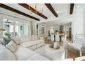 Spacious living room flows to the kitchen area with an open floor plan, lots of natural light, and wood beam ceilings at 2048 Ten Point Dr, Charleston, SC 29492
