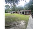 Wide shot of a brick home showcasing its lawn and exterior at 214 Winter St, Moncks Corner, SC 29461