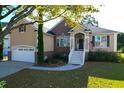 Beautiful home with a two-car garage, brick and stucco accents, and a charming front entrance at 2206 Magnolia Meadows Dr, Mount Pleasant, SC 29464