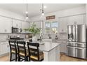 Modern kitchen features stainless steel appliances, granite countertops, large center island, and ample storage space at 226 Midtown Ave, Summerville, SC 29486