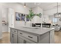 Elegant kitchen island with white cabinetry, quartz countertops, and stylish decor at 226 Midtown Ave, Summerville, SC 29486