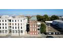 A three-story brick home with many windows sits between two streets in an urban setting at 286 Meeting St # C, Charleston, SC 29407
