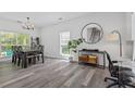 Sunlit dining room features modern chandelier and stylish gray flooring at 3202 Middleburry Ln, Charleston, SC 29414