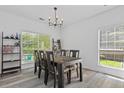 Rustic wood dining table with seating for six near a window with natural light at 3202 Middleburry Ln, Charleston, SC 29414