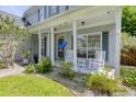 Inviting front porch with rocking chairs, a swing, and manicured landscaping at 3202 Middleburry Ln, Charleston, SC 29414