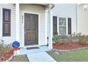 Close-up view of the home's front door and well-maintained landscaping at 4936 Ballantine Dr, Summerville, SC 29485