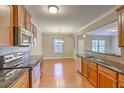 Open kitchen with granite countertops, stainless steel appliances, and hardwood floors at 4936 Ballantine Dr, Summerville, SC 29485