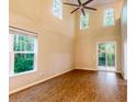 Spacious living room features high ceilings, large windows, and elegant laminate flooring for a clean, modern aesthetic at 5001 Hay Bale Ct, Summerville, SC 29485