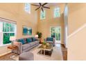 Bright living room boasts high ceilings, large windows, stylish furnishings, and a serene atmosphere perfect for relaxation at 5001 Hay Bale Ct, Summerville, SC 29485