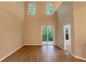 Open-concept living area with laminate flooring and sliding glass doors leading to a serene outdoor space at 5001 Hay Bale Ct, Summerville, SC 29485
