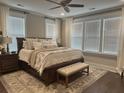 Bright main bedroom with hardwood floors, neutral paint, large windows and stylish furnishings at 525 Scholar Way, Summerville, SC 29486