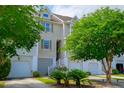 Charming townhome featuring an attached garage and manicured front yard at 543 Mclernon Trce, Johns Island, SC 29455
