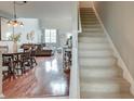Inviting living area featuring hardwood floors, stairs, and large windows at 543 Mclernon Trce, Johns Island, SC 29455