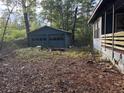 View of the yard showing the side of the house and a detached garage at 7112 Old Jacksonboro Rd, Ravenel, SC 29470