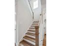 Carpeted staircase with white risers and wood railing, leading to the upper level of the home at 78 French Garden Cir, Summerville, SC 29486