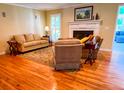 Comfortable living room with hardwood floors, fireplace, neutral walls, and cozy furniture at 946 Law Ln, Mount Pleasant, SC 29464