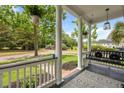 Inviting front porch with a porch swing, hanging plants, and an outdoor rug at 101 Barberry St, Summerville, SC 29483