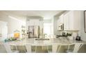 Open kitchen with granite countertops, stainless steel appliances, and bright white cabinetry at 1034 Scotch Bonnet Way, Summerville, SC 29485