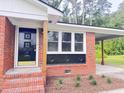 Close-up of the house entrance showing the updated front door and brick work detail and window design at 105 Dandridge Rd, Walterboro, SC 29488
