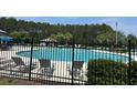 Enjoy the community pool with lounge chairs and a fenced perimeter for added security at 107 Brookhaven Rd, Summerville, SC 29486